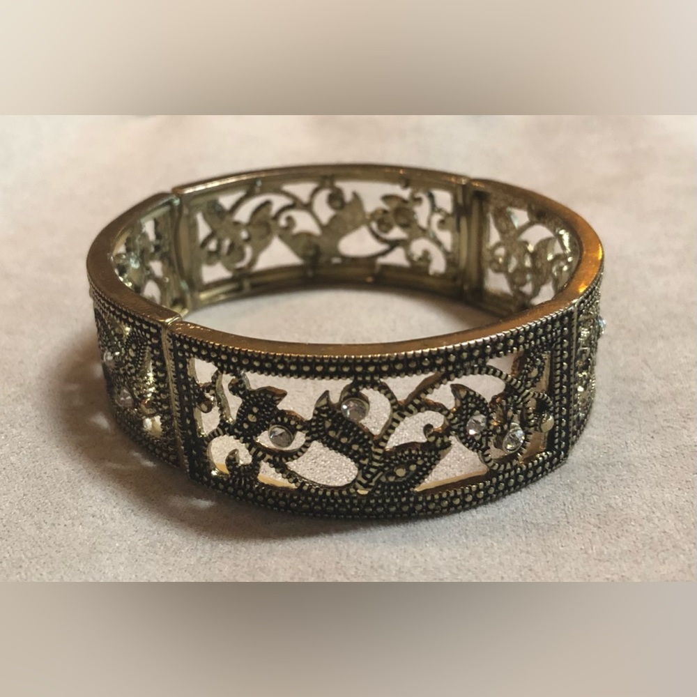 Gold tone cuff bracelet.